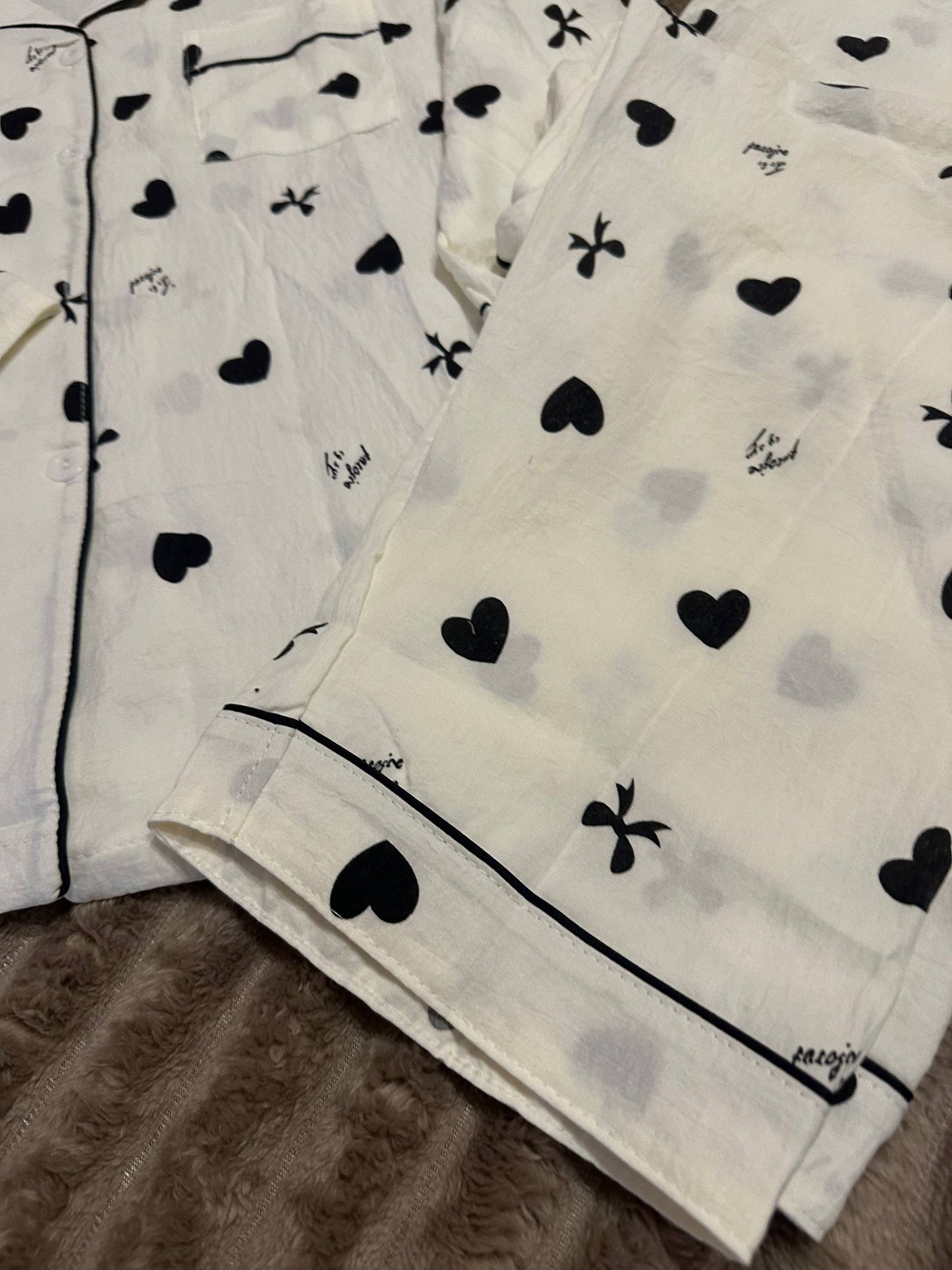 Women’s white pajama set with black hearts and bows – button-up shirt and pants