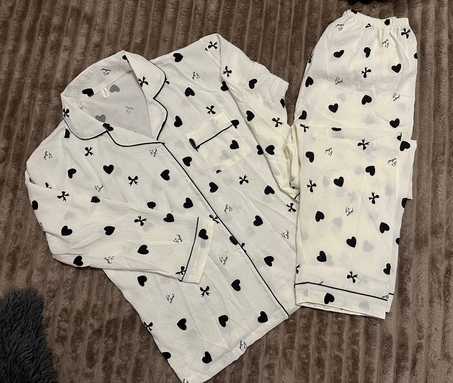 Women’s white pajama set with black hearts and bows – button-up shirt and pants