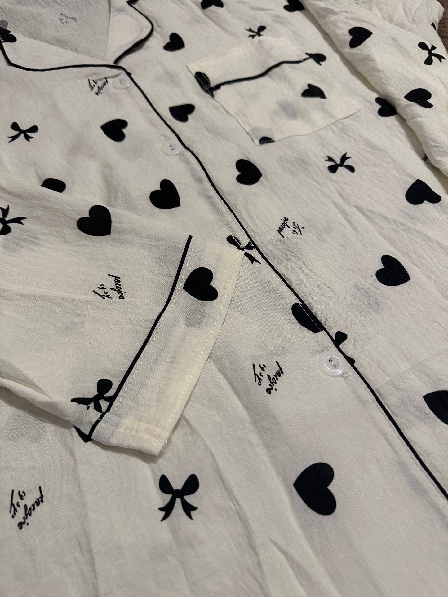 Women’s white pajama set with black hearts and bows – button-up shirt and pants