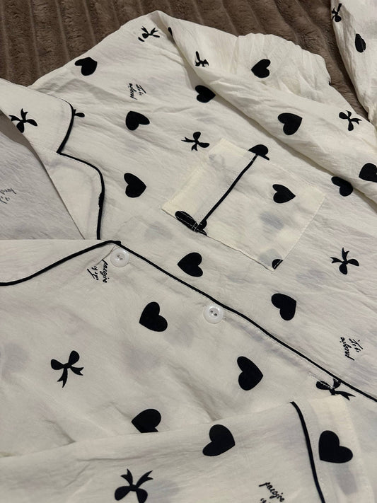 Women’s white pajama set with black hearts and bows – button-up shirt and pants